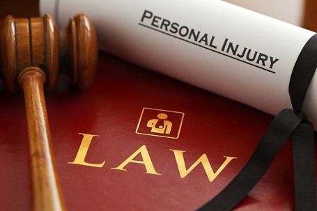 Personal Injury Scroll on top of a book that says Law