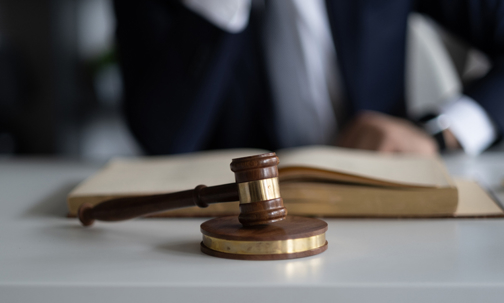 Gavel in front of a blurred out man
